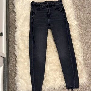 Black jeans with distressed bottoms